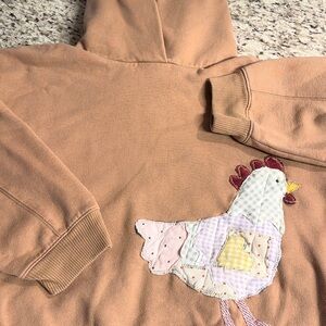 Upcycled tan hoodie with quilted chicken patchwork design.